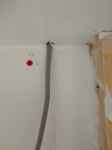 Push button cable run up through hole in ceiling