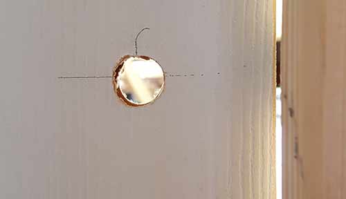 Spindle hole drilled through door