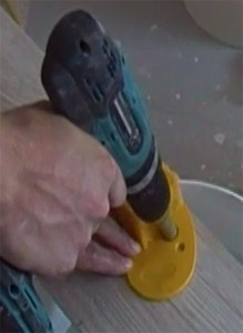 Make sure the drill doesn't slip by using a guide plate to drill through porcelain tiles
