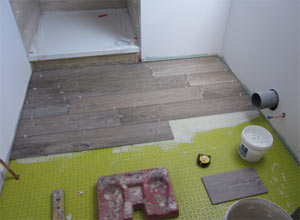 Wood grain effect Porcelain tiles laid in half bond brick pattern on a bathroom floor