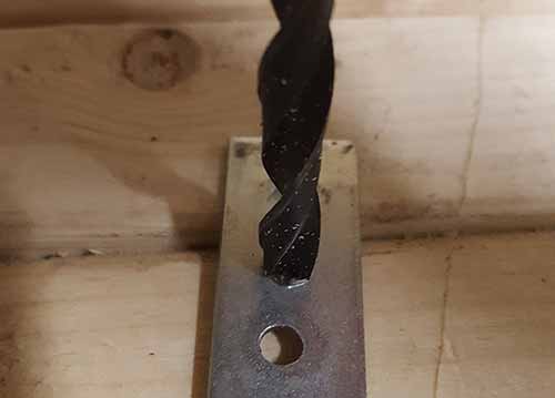 Removing burrs with a drill bit