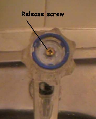 Removing the cover and indicator will show the screw which can be undone