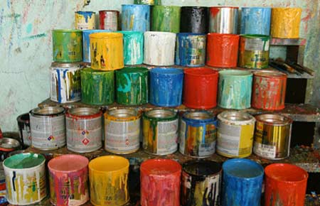 Many cans of half used paint