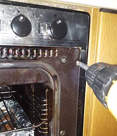 Remove retaining screws from oven