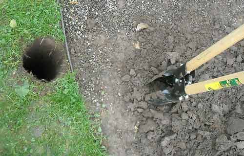 Remove soil with post hole diggers