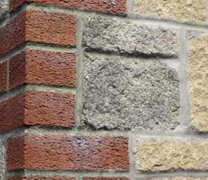 Masonry wall with brick and stone