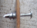 Reddi drive screwed into wall with screw inserted ready for fixing