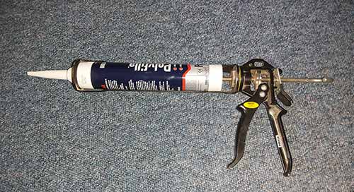 Caulk cartridge inserted into caulk gun