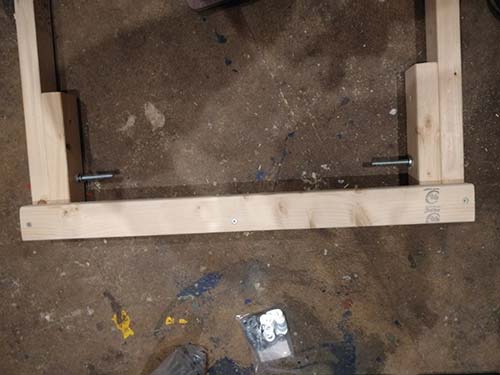 Leg stay screwed to underside of workbench