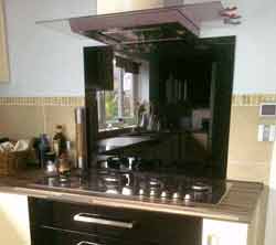 Acrylic splashback fitted behind cooker in kitchen