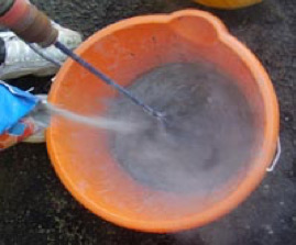 Mixing tile grout in a bucket using a paddle mixer