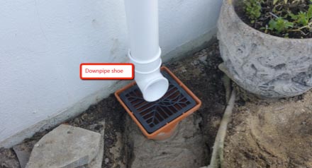 Shoe fitted to base of downpipe