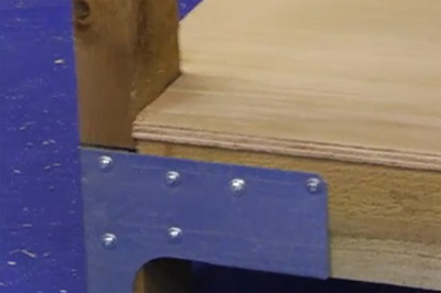 Screwing down shelf to rails