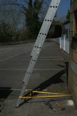 Ladder strapped safely to wall