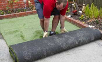Laying artificial grass on hard surface