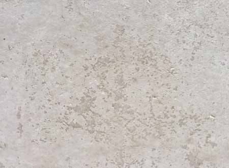 Laitance flaking off a dried liquid screed