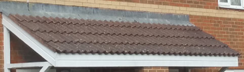 Lead flashing on a long porch roof dressed over tiles