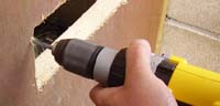 Using a cordless drill to drill letter box bolt holes