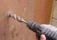 Drilling  holes in hardwood door