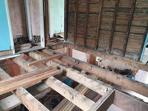 Ceiling pulled down to expose joists