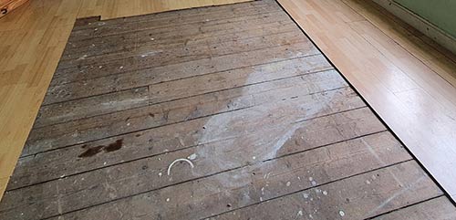Remove any floor coverings to access floor boards and joists