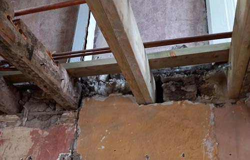 Crumbling brickwork repaired to support joist end