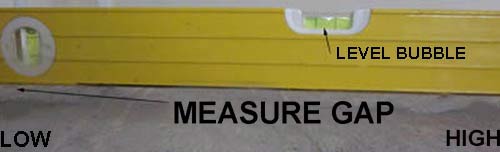 Using a spirit level to check the level of a floor