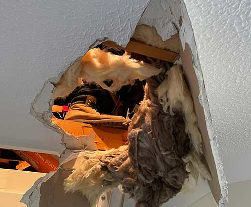 Hole in ceiling where someones put their foot through from in the loft