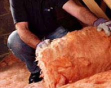 Rolling out insulation in the loft