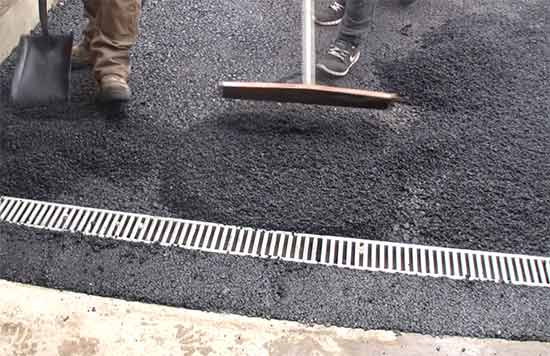 Laying top coat around drain