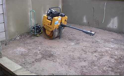 Compacting sub base using single drum roller