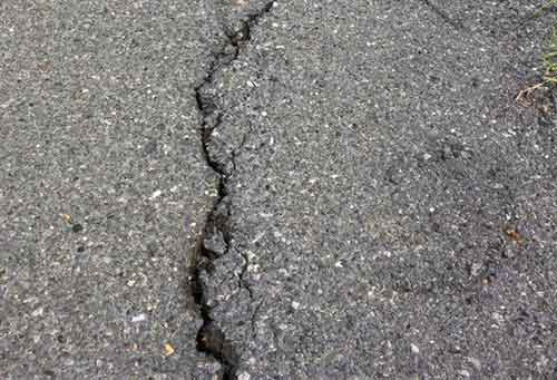 Unsupported edge of macadam cracked