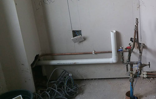 Kitchen units removed to access waste pipes