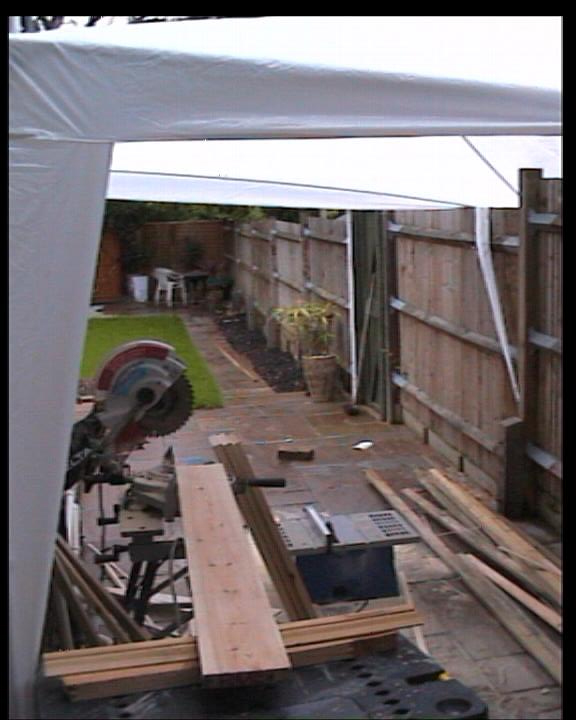 Chop Saw and Table Saw situated outside with awning covering it