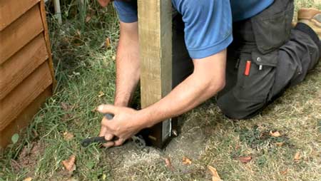 Tighten the bolts to hold fence post in place