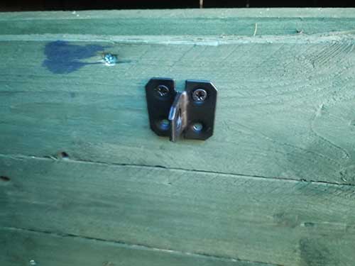 Gate latch keep screwed to back of nesting box