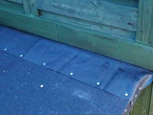 Pallet slat fixed over rubber to seal join