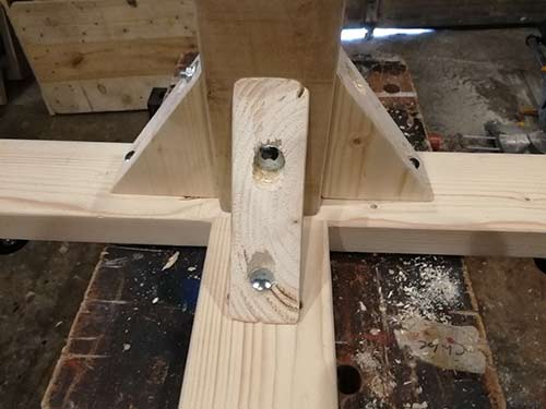 Timber support brackets fixed to office chair base and centre support