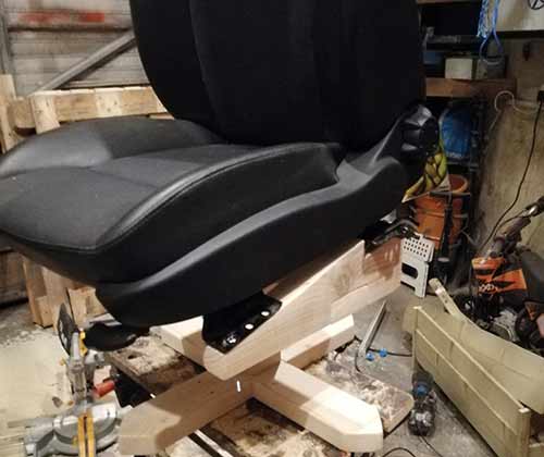 Car seat placed on top of office chair structure