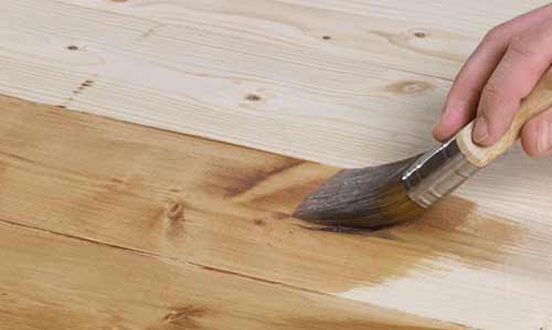 Applying varnish to ledge and brace door