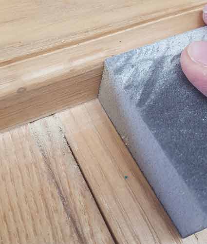 Using a sanding block to sand down ledges