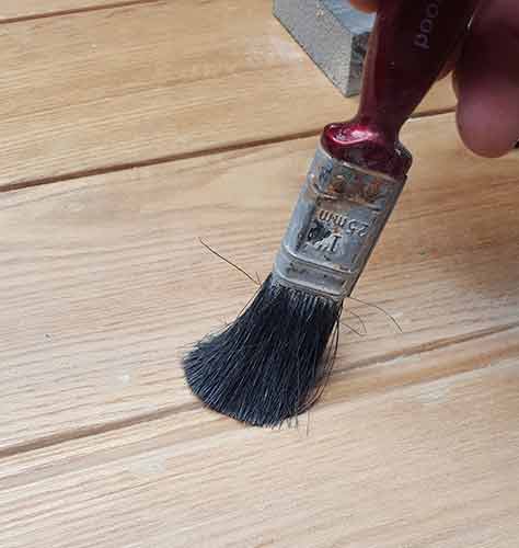 Using paint brush to clean dust from detail areas