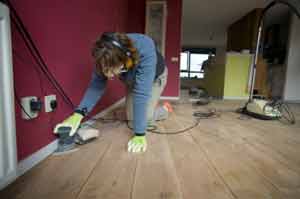 Detail sanding the wooden floor