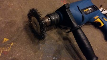 Power drill with wire brush attachment