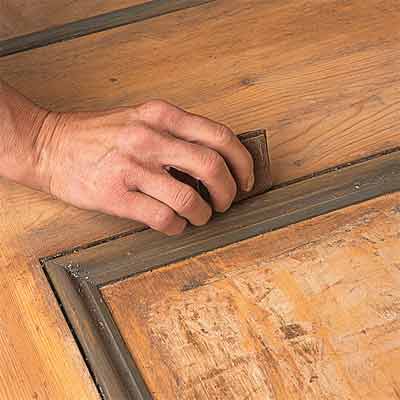 Rubbing down wooden panel door