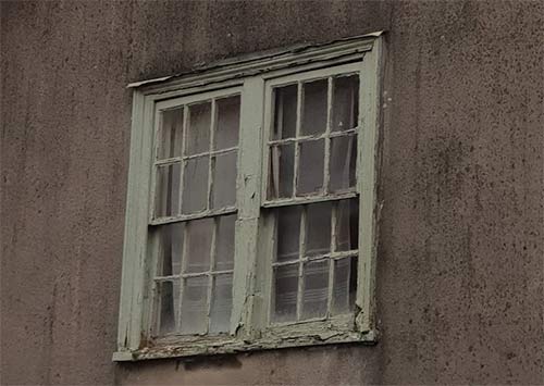 Traditional wooden sash window in poor condition