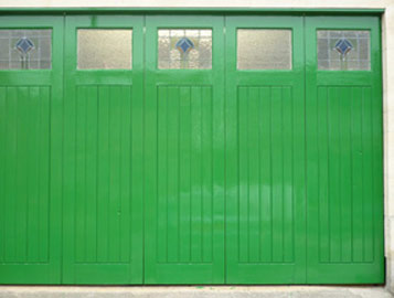 Wooden garage door with top coat paint