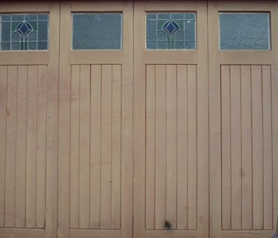 Unpainted wooden garage doors