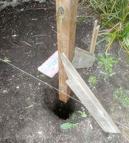 Support fence post using scrap timbers