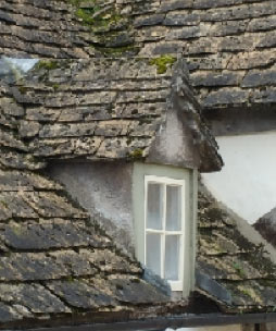 Dormer window in stone tiled roof